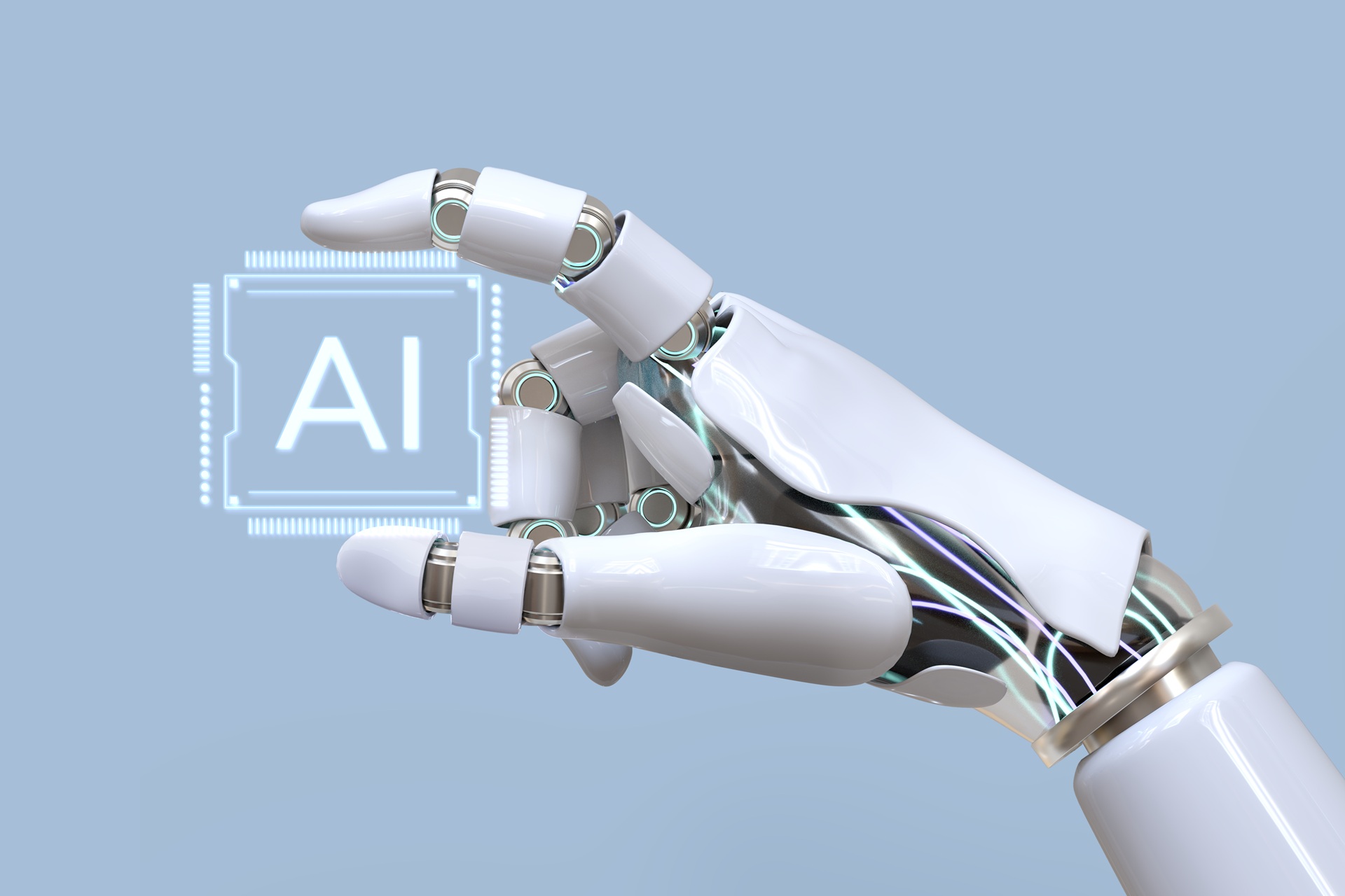 Obraz przedstawiający rękę robota trzymającą czip z napisem AI - sztuczna inteligencja
